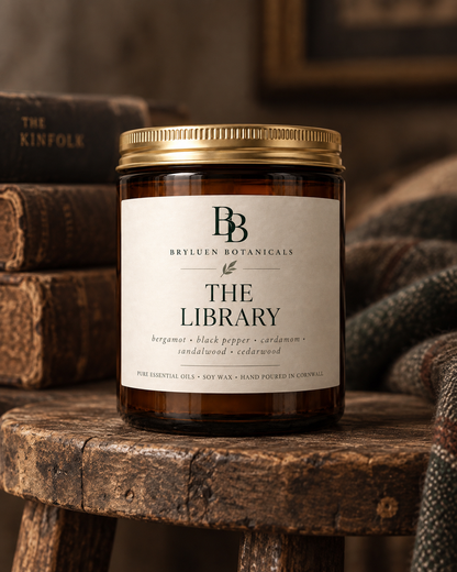 The Library natural soy wax candle by Bryluen Botanicals, photographed with antique books