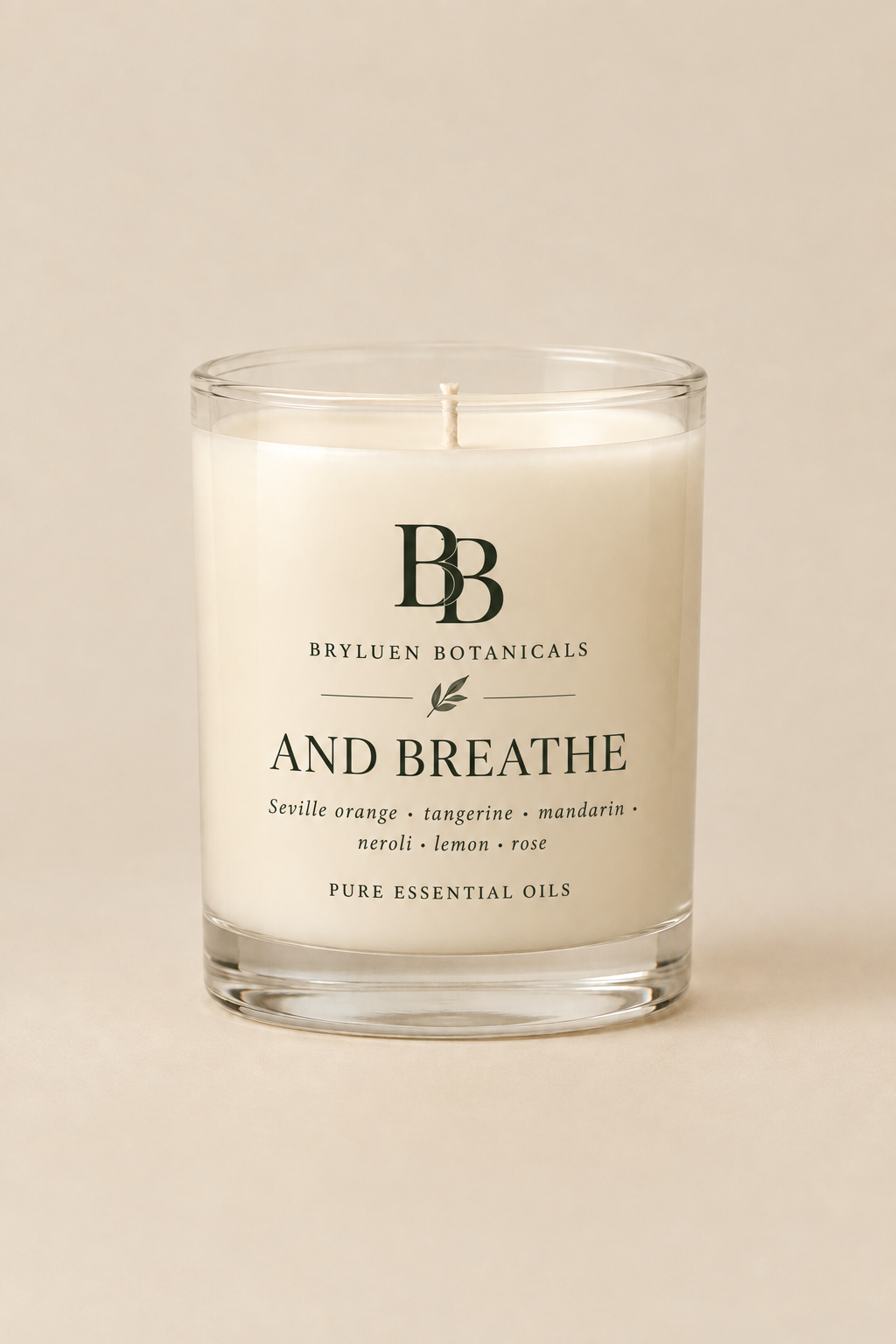 And Breathe candle by Bryluen Botanicals in clear glass, unlit, with a minimal transparent label